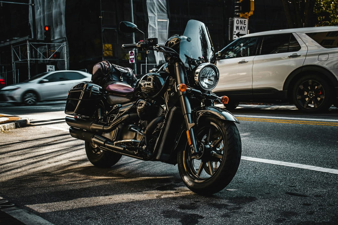 a black touring motorcycle parked on a city street