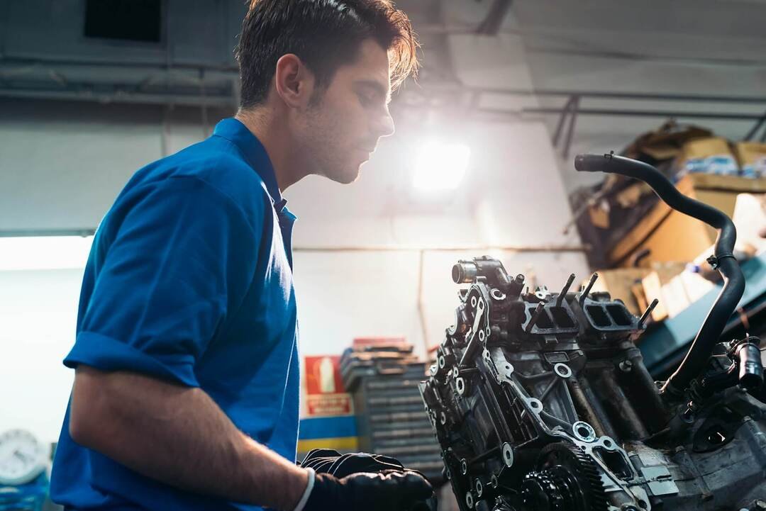 mechanic checking a car engine