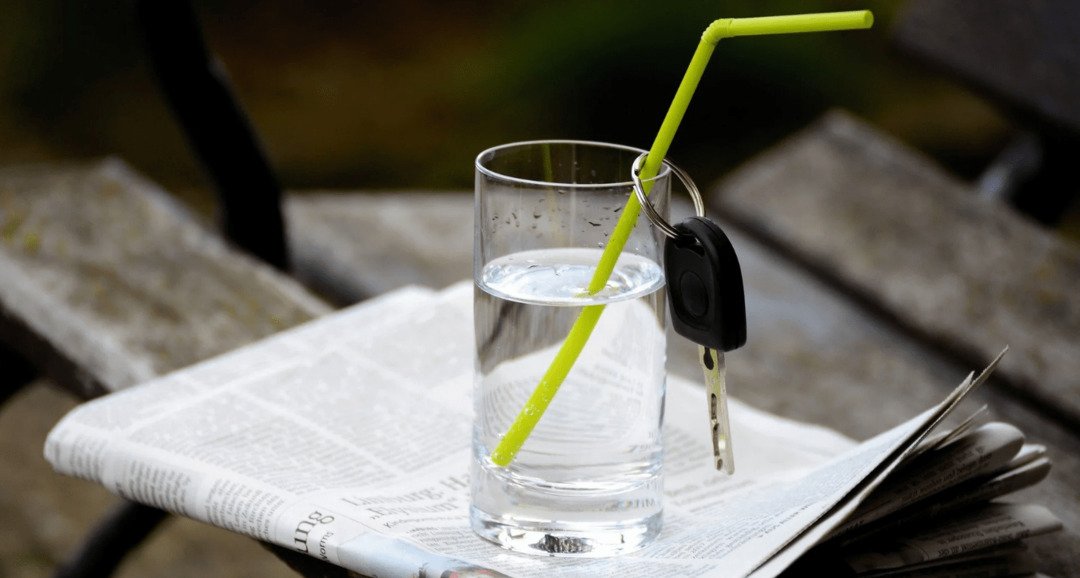 Llaves del coche cerca del vaso de agua.