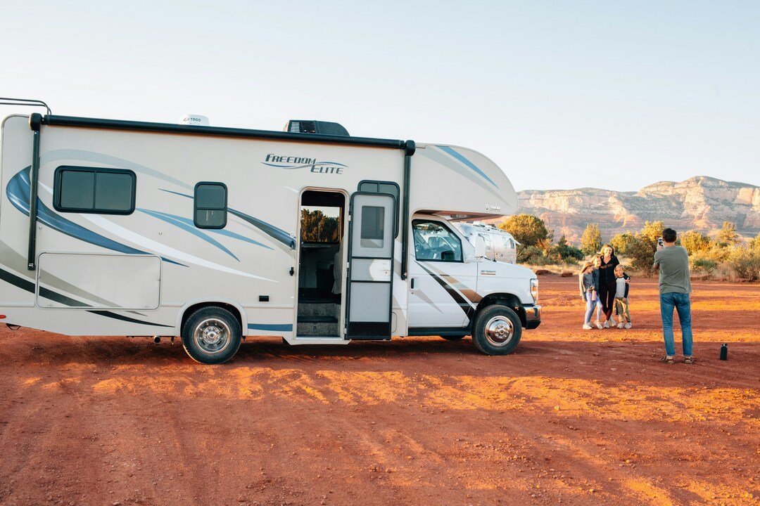 family near a travel trailer