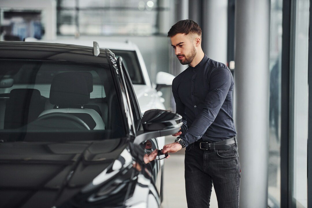 man opening doors of his new car