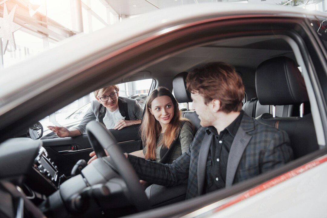 young couple at a car dealership