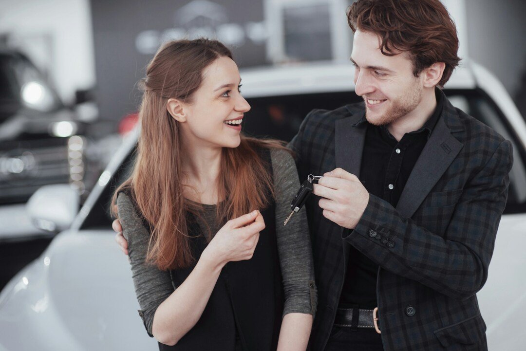 new car owners at a dealership