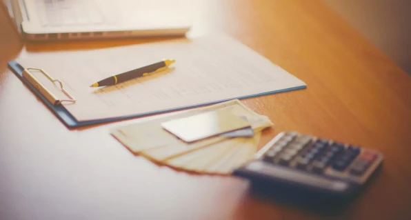 Papers with a calculator on the table