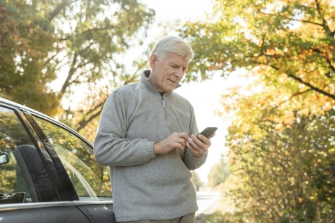 Man with broken car on the road