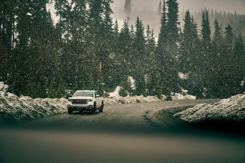 a white SUV on the snowy road in winter